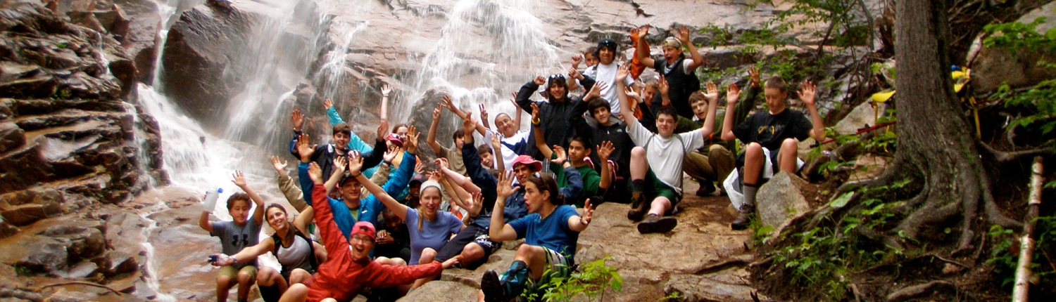 a large group pf teen students celebrating their hike near a