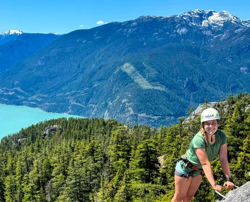 teen girl climbing a via ferrata in squamish british columbia during teen summer camp