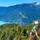 teen girl climbing a via ferrata in squamish british columbia during teen summer camp