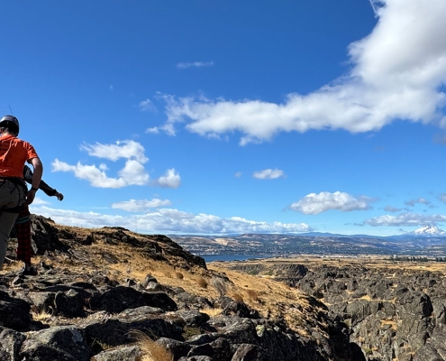 teen boy hiking in a rock climbing harness in columbia river gorge on teen adventure camp