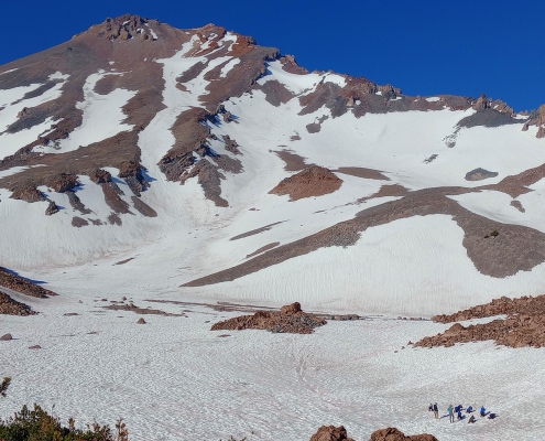 teenagers hiking on the side of mount shastina in california