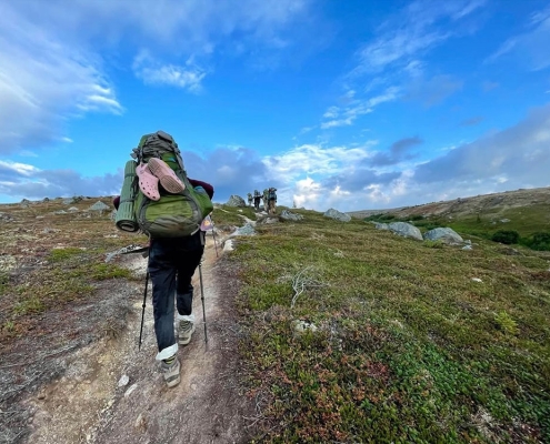 Teenagers backpacking in Alaska during a summer outdoor adventure camp