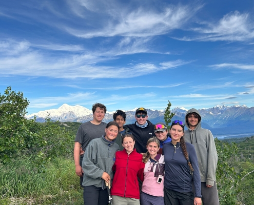 teenagers standing in denali state park with denali or mt. mckinley in the background on a sunny day at teen adventure camp