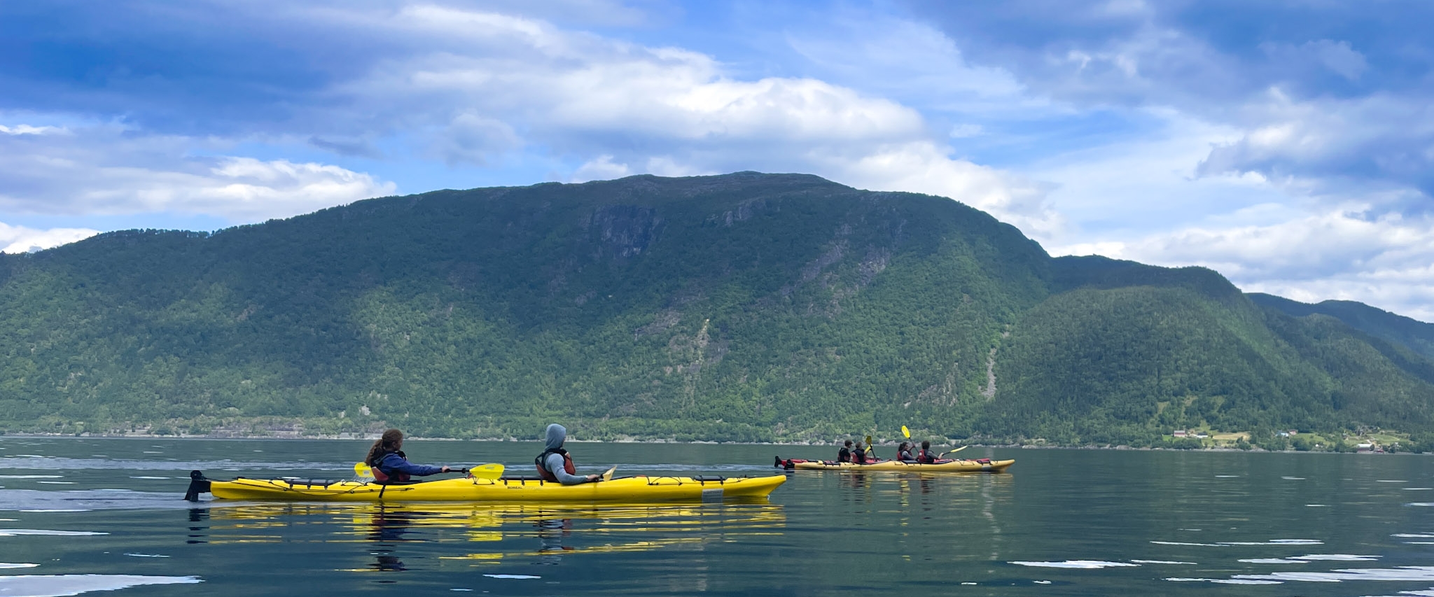 teenagers sea kayaking in norway fjord at summer camp teenagers sea kayaking in norway fjord at summer camp