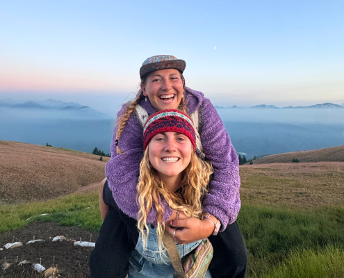 two young adults smiling in front of a beautiful sunset two young adults smiling in front of a beautiful sunset