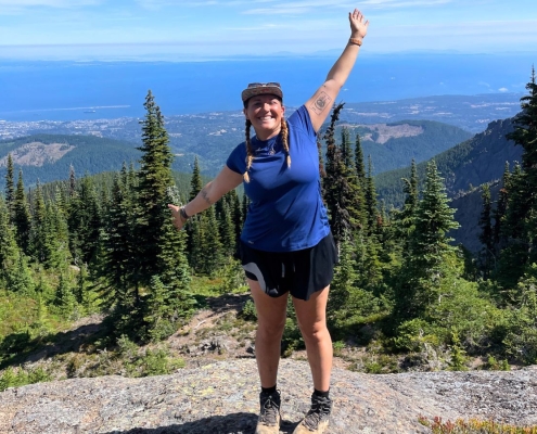 young woman posing in front of a view full of trees at teen adventure camp young woman posing in front of a view full of trees at teen adventure camp