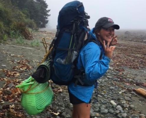young teen posing with backpack full of gear on trek during summer adventure camp for teens young teen posing with backpack full of gear on trek during summer adventure camp for teens