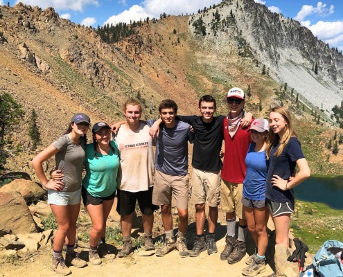 group of teens smiling on a hike at a teen summer adventure camp group of teens smiling on a hike at a teen summer adventure camp