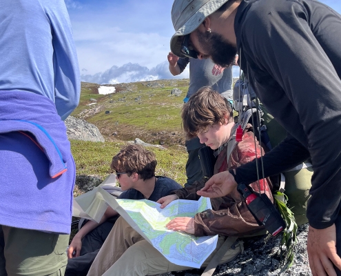 alaska-expedition-teen-boy-reading-map-while-hiking alaska-expedition-teen-boy-reading-map-while-hiking