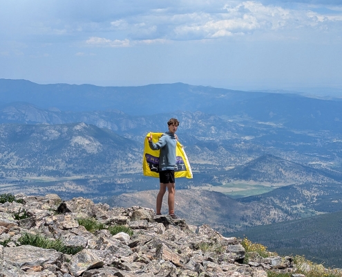 colorado-explorer-boy-with-AT-flag-on-summit colorado-explorer-boy-with-AT-flag-on-summit